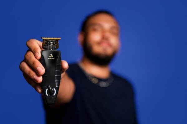 “Andis GTX‑EXO trimmer 74150 in black on charging stand, showing gold T‑blade and ergonomic handle” “GTX‑EXO cordless trimmer highlighting blade and charging dock accessories”
