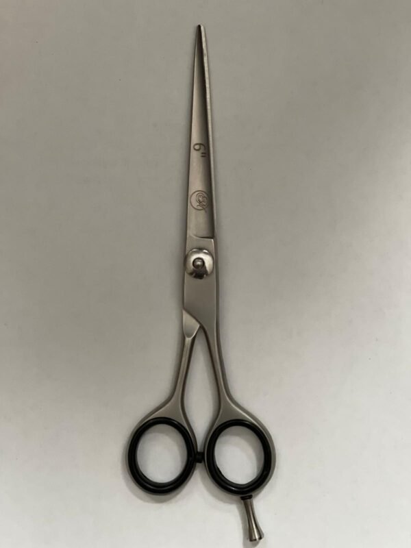 7-inch-professional-barber-scissors-stainless-steel-razor-edge.jpg  "Close-up of professional 7-inch barber scissors with silver stainless steel blades and an ergonomic offset handle."  barber-using-7-inch-shears-for-scissor-over-comb.jpg "Professional barber performing a scissor-over-comb technique using 7-inch hair cutting shears."  razor-edge-hollow-ground-blade-detail.jpg "Macro shot of the hand-honed razor edge on high-carbon steel barber scissors."