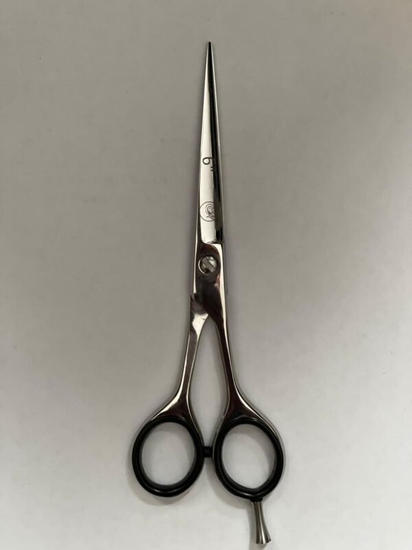 7-inch-professional-barber-scissors-stainless-steel-razor-edge.jpg  "Close-up of professional 7-inch barber scissors with silver stainless steel blades and an ergonomic offset handle."  barber-using-7-inch-shears-for-scissor-over-comb.jpg "Professional barber performing a scissor-over-comb technique using 7-inch hair cutting shears."  razor-edge-hollow-ground-blade-detail.jpg "Macro shot of the hand-honed razor edge on high-carbon steel barber scissors."