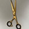 7-inch-professional-barber-scissors-stainless-steel-razor-edge.jpg  "Close-up of professional 7-inch barber scissors with silver stainless steel blades and an ergonomic offset handle."  barber-using-7-inch-shears-for-scissor-over-comb.jpg "Professional barber performing a scissor-over-comb technique using 7-inch hair cutting shears."  razor-edge-hollow-ground-blade-detail.jpg "Macro shot of the hand-honed razor edge on high-carbon steel barber scissors."
