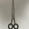 7-inch-professional-barber-scissors-stainless-steel-razor-edge.jpg  "Close-up of professional 7-inch barber scissors with silver stainless steel blades and an ergonomic offset handle."  barber-using-7-inch-shears-for-scissor-over-comb.jpg "Professional barber performing a scissor-over-comb technique using 7-inch hair cutting shears."  razor-edge-hollow-ground-blade-detail.jpg "Macro shot of the hand-honed razor edge on high-carbon steel barber scissors."