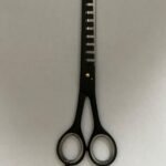 7-inch-professional-barber-scissors-stainless-steel-razor-edge.jpg  "Close-up of professional 7-inch barber scissors with silver stainless steel blades and an ergonomic offset handle."  barber-using-7-inch-shears-for-scissor-over-comb.jpg "Professional barber performing a scissor-over-comb technique using 7-inch hair cutting shears."  razor-edge-hollow-ground-blade-detail.jpg "Macro shot of the hand-honed razor edge on high-carbon steel barber scissors."