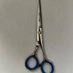 7-inch-professional-barber-scissors-stainless-steel-razor-edge.jpg  "Close-up of professional 7-inch barber scissors with silver stainless steel blades and an ergonomic offset handle."  barber-using-7-inch-shears-for-scissor-over-comb.jpg "Professional barber performing a scissor-over-comb technique using 7-inch hair cutting shears."  razor-edge-hollow-ground-blade-detail.jpg "Macro shot of the hand-honed razor edge on high-carbon steel barber scissors."