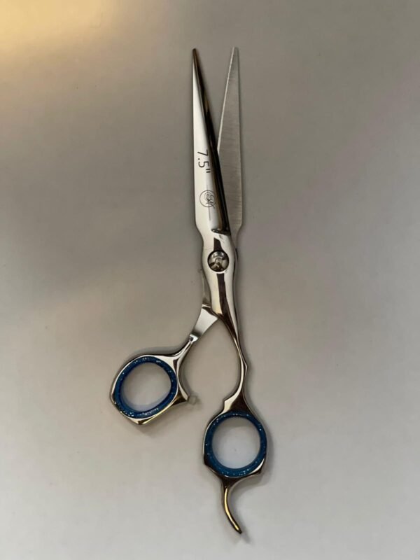 7-inch-professional-barber-scissors-stainless-steel-razor-edge.jpg  "Close-up of professional 7-inch barber scissors with silver stainless steel blades and an ergonomic offset handle."  barber-using-7-inch-shears-for-scissor-over-comb.jpg "Professional barber performing a scissor-over-comb technique using 7-inch hair cutting shears."  razor-edge-hollow-ground-blade-detail.jpg "Macro shot of the hand-honed razor edge on high-carbon steel barber scissors."