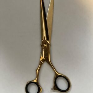 7-inch-professional-barber-scissors-stainless-steel-razor-edge.jpg  "Close-up of professional 7-inch barber scissors with silver stainless steel blades and an ergonomic offset handle."  barber-using-7-inch-shears-for-scissor-over-comb.jpg "Professional barber performing a scissor-over-comb technique using 7-inch hair cutting shears."  razor-edge-hollow-ground-blade-detail.jpg "Macro shot of the hand-honed razor edge on high-carbon steel barber scissors."