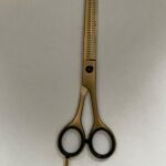 7-inch-professional-barber-scissors-stainless-steel-razor-edge.jpg  "Close-up of professional 7-inch barber scissors with silver stainless steel blades and an ergonomic offset handle."  barber-using-7-inch-shears-for-scissor-over-comb.jpg "Professional barber performing a scissor-over-comb technique using 7-inch hair cutting shears."  razor-edge-hollow-ground-blade-detail.jpg "Macro shot of the hand-honed razor edge on high-carbon steel barber scissors."