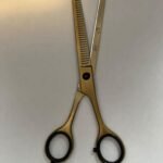 7-inch-professional-barber-scissors-stainless-steel-razor-edge.jpg  "Close-up of professional 7-inch barber scissors with silver stainless steel blades and an ergonomic offset handle."  barber-using-7-inch-shears-for-scissor-over-comb.jpg "Professional barber performing a scissor-over-comb technique using 7-inch hair cutting shears."  razor-edge-hollow-ground-blade-detail.jpg "Macro shot of the hand-honed razor edge on high-carbon steel barber scissors."