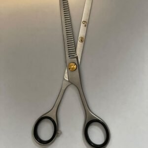 7-inch-professional-barber-scissors-stainless-steel-razor-edge.jpg "Close-up of professional 7-inch barber scissors with silver stainless steel blades and an ergonomic offset handle." barber-using-7-inch-shears-for-scissor-over-comb.jpg "Professional barber performing a scissor-over-comb technique using 7-inch hair cutting shears." razor-edge-hollow-ground-blade-detail.jpg "Macro shot of the hand-honed razor edge on high-carbon steel barber scissors."