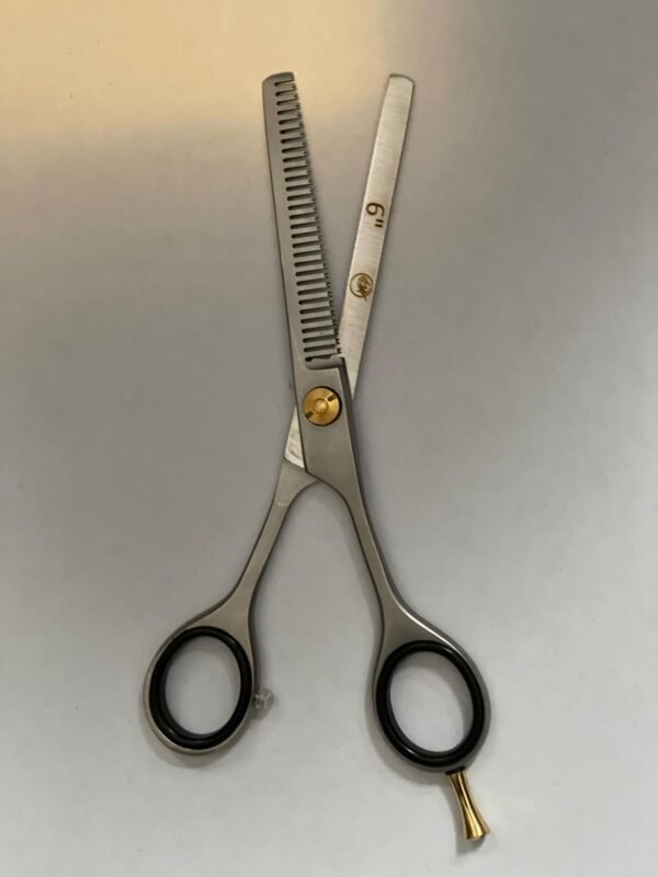 7-inch-professional-barber-scissors-stainless-steel-razor-edge.jpg  "Close-up of professional 7-inch barber scissors with silver stainless steel blades and an ergonomic offset handle."  barber-using-7-inch-shears-for-scissor-over-comb.jpg "Professional barber performing a scissor-over-comb technique using 7-inch hair cutting shears."  razor-edge-hollow-ground-blade-detail.jpg "Macro shot of the hand-honed razor edge on high-carbon steel barber scissors."
