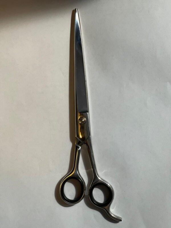 7-inch-professional-barber-scissors-stainless-steel-razor-edge.jpg  "Close-up of professional 7-inch barber scissors with silver stainless steel blades and an ergonomic offset handle."  barber-using-7-inch-shears-for-scissor-over-comb.jpg "Professional barber performing a scissor-over-comb technique using 7-inch hair cutting shears."  razor-edge-hollow-ground-blade-detail.jpg "Macro shot of the hand-honed razor edge on high-carbon steel barber scissors."