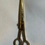 7-inch-professional-barber-scissors-stainless-steel-razor-edge.jpg  "Close-up of professional 7-inch barber scissors with silver stainless steel blades and an ergonomic offset handle."  barber-using-7-inch-shears-for-scissor-over-comb.jpg "Professional barber performing a scissor-over-comb technique using 7-inch hair cutting shears."  razor-edge-hollow-ground-blade-detail.jpg "Macro shot of the hand-honed razor edge on high-carbon steel barber scissors."