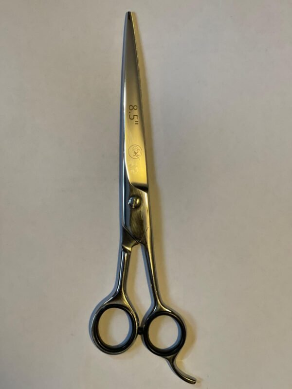 7-inch-professional-barber-scissors-stainless-steel-razor-edge.jpg  "Close-up of professional 7-inch barber scissors with silver stainless steel blades and an ergonomic offset handle."  barber-using-7-inch-shears-for-scissor-over-comb.jpg "Professional barber performing a scissor-over-comb technique using 7-inch hair cutting shears."  razor-edge-hollow-ground-blade-detail.jpg "Macro shot of the hand-honed razor edge on high-carbon steel barber scissors."
